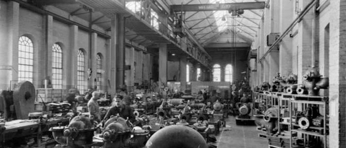 Old monochrome image of the foundry building being used as a workshop.